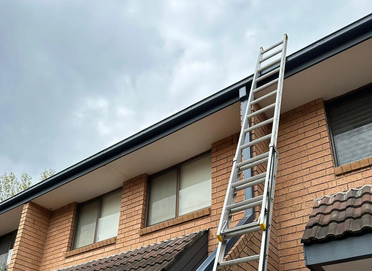 Completed guttering viewed along the upper roofline of a brick home