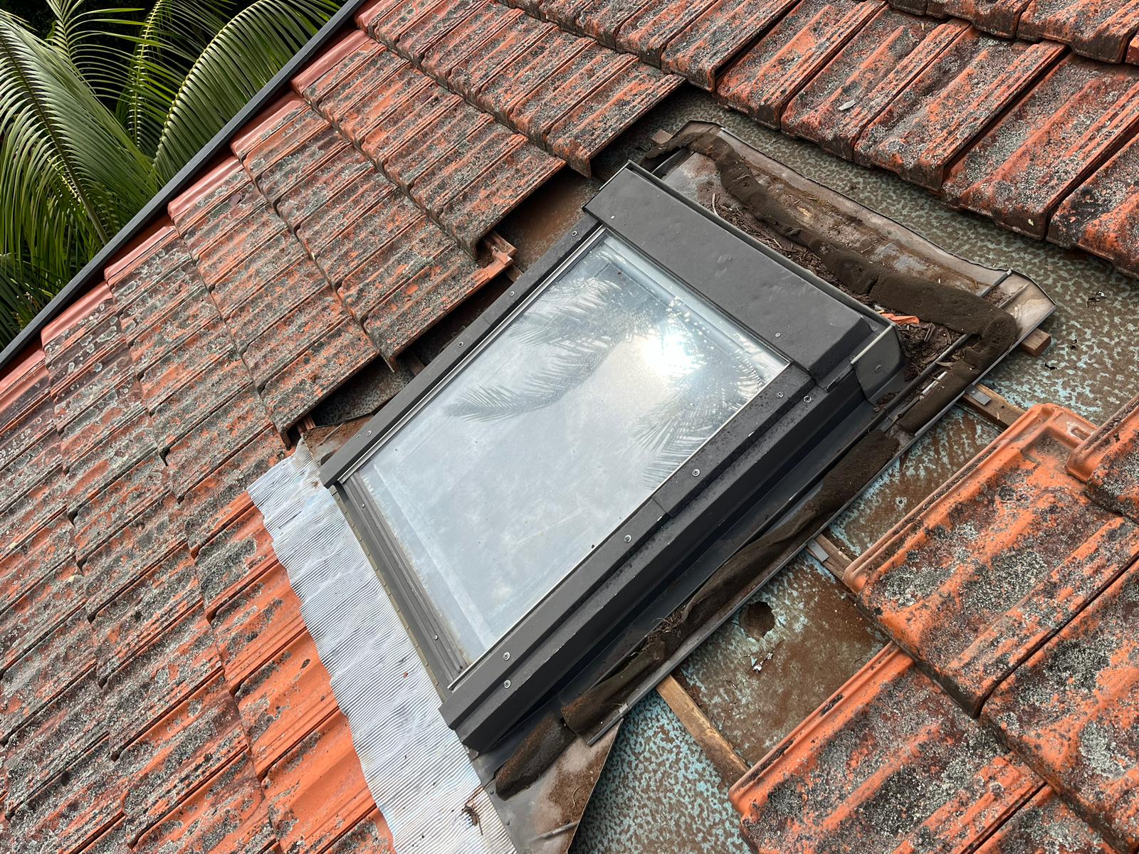 Existing skylight and surrounding tiled roof before replacement work in Sydney