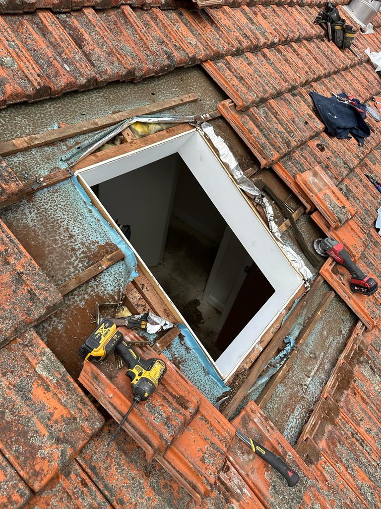 Roof opening and surrounding tiles during skylight installation in Sydney